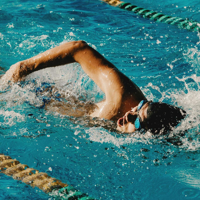 Professional swimmer training in a pool doing the front crawl stroke